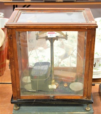 Lot 157 - A set of brass laboratory scales in teak case,...