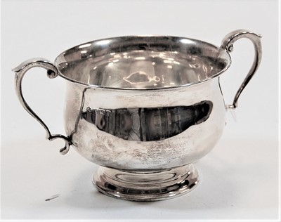 Lot 269 - A silver twin handled cup, standing on a...