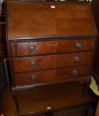 Lot 1221 - A 1920s mahogany slopefront three drawer...