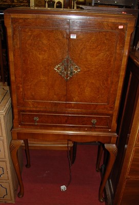 Lot 1269 - A 1930s walnut and figured walnut double door...