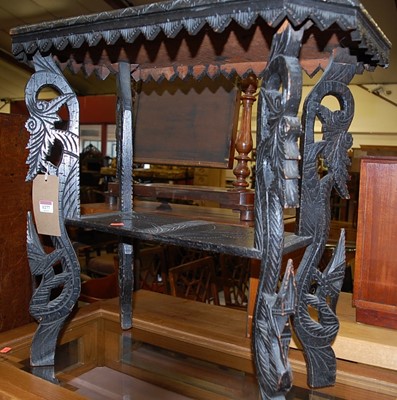 Lot 1277 - An ebonised and line carved oak two-tier...