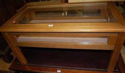 Lot 1278 - A contemporary oak and glazed coffee table,...
