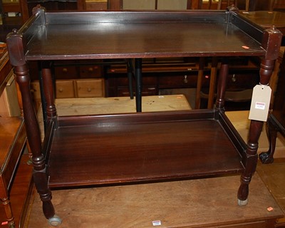 Lot 1299 - A mahogany two-tier tea trolley, raised on...