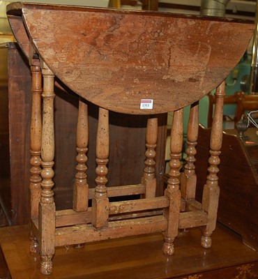 Lot 1311 - A small oak drop flap gateleg occasional table...