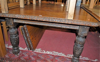Lot 1328 - A circa 1900 heavily carved floral oak round...