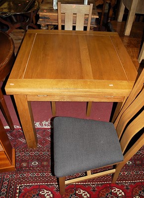 Lot 1329 - A contemporary oak dining suite comprising;...
