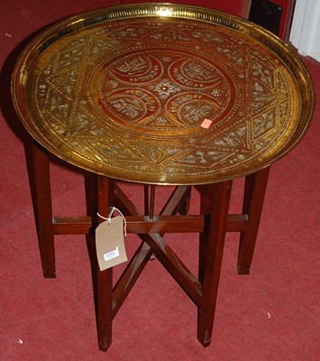 Lot 1351 - An Eastern engraved circular brass topped...