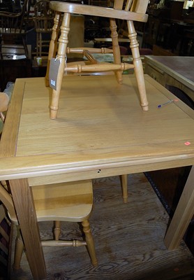 Lot 1373 - A contemporary light oak dining table,...