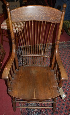 Lot 1375 - An early 20th century oak stickback elbow...