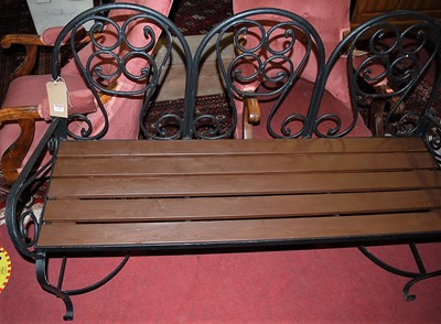 Lot 1385 - A black painted wrought iron and stained teak...