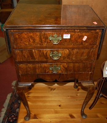 Lot 1432 - A 1930s figured walnut drop-flap three drawer...