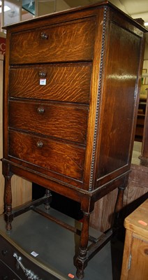 Lot 1446 - A 1920s oak ledge back four drawer music chest,...