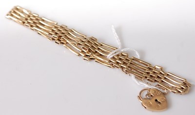 Lot 354 - A 9ct gold gatelink bracelet with heart shaped...