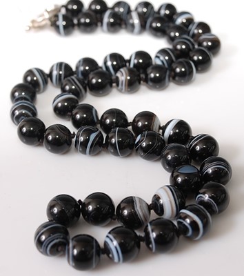 Lot 382 - A knotted banded agate beaded necklace with...