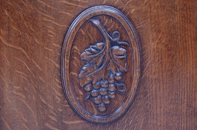 Lot 290 - An Arts & Crafts oak ledgeback side cupboard,...