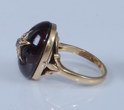 Lot 1206 - A yellow metal oval garnet mourning ring,...