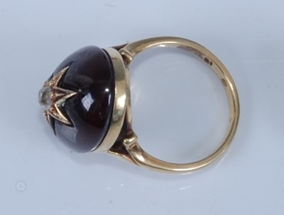 Lot 1206 - A yellow metal oval garnet mourning ring,...