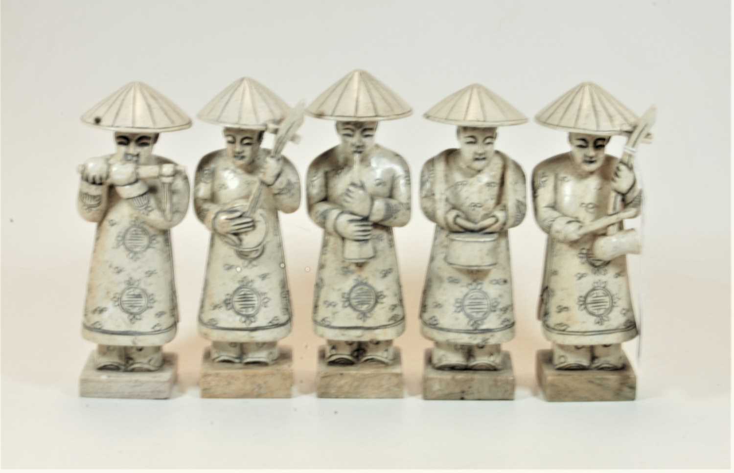 Lot 22 - A set of five carved stone figures, each in...