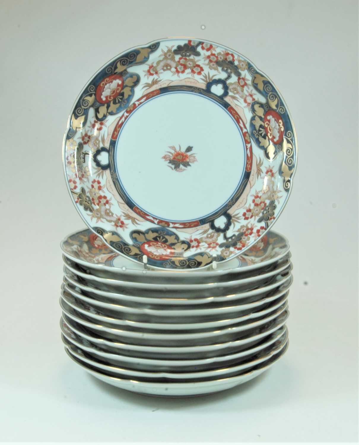 Lot 33 - A set of 12 Japanese plates of shaped circular...