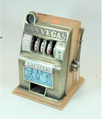 Lot 91 - A novelty table-top moneybox in the form of a...