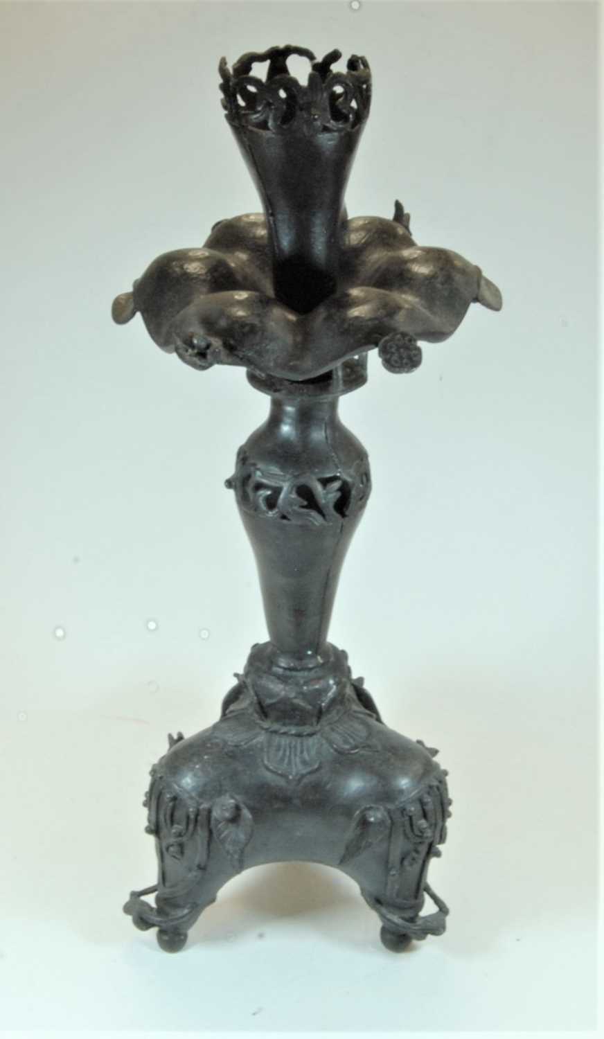 Lot 98 - An Eastern spelter table candle stand, having...