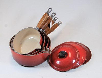 Lot 99 - A graduated set of four Le Creuset red...