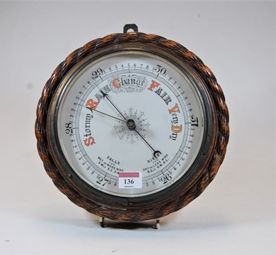 Lot 136 - An early 20th century aneroid barometer housed...