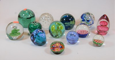 Lot 193 - A collection of glass paperweights, together...
