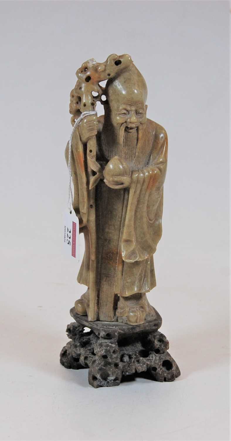 Lot 225 - A Chinese carved soapstone figure of Shou Lao,...