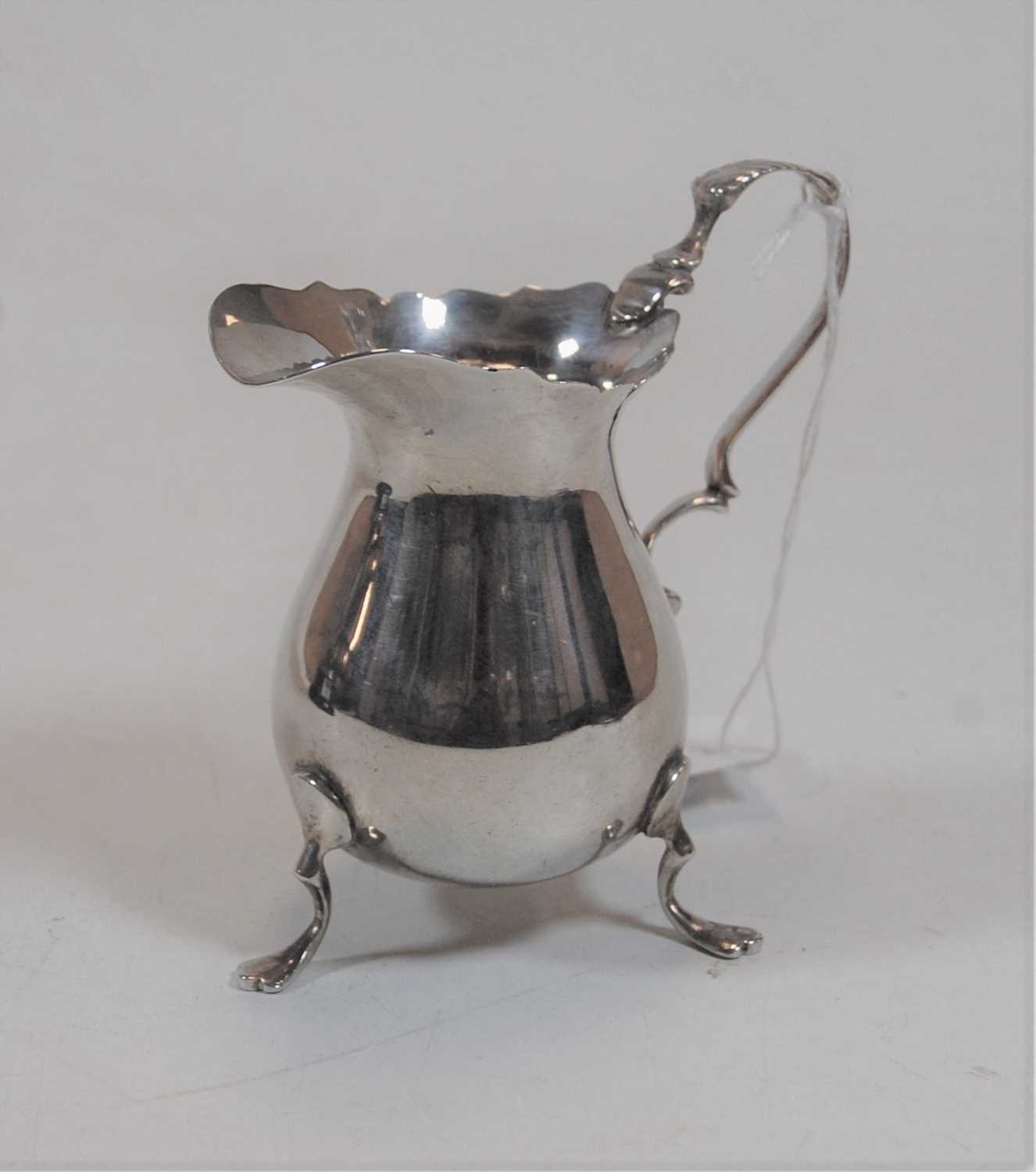 Lot 241 - A silver helmet form cream jug in the George...