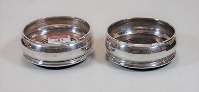Lot 253 - A pair of modern silver coasters with turned...