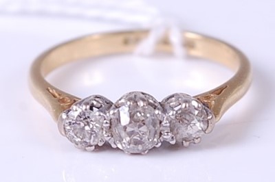 Lot 358 - An 18ct gold diamond three stone ring, the...