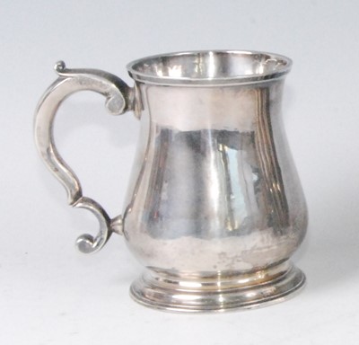 Lot 1165 - A George II silver bell-shaped tankard, having...