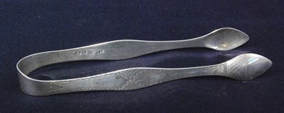 Lot 1159 - A pair of early George III silver sugar tongs,...