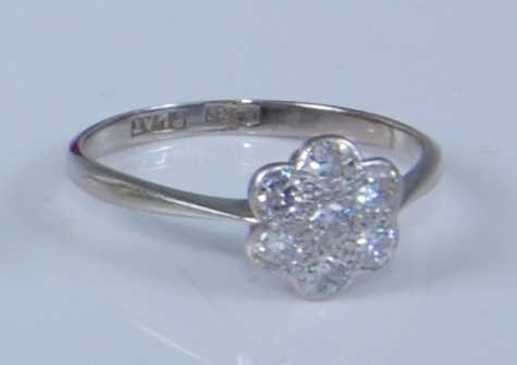 Lot 1208 - A white metal diamond circular cluster ring,...