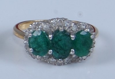Lot 1207 - An 18ct yellow and white gold, emerald and...
