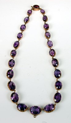 Lot 1236 - A yellow metal amethyst necklet, featuring 24...