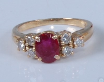 Lot 1205 - A yellow metal, ruby and diamond dress ring,...