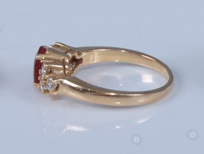 Lot 1205 - A yellow metal, ruby and diamond dress ring,...
