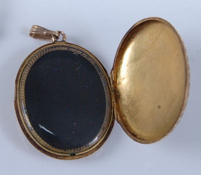 Lot 1254 - A yellow metal mourning brooch and locket, the...