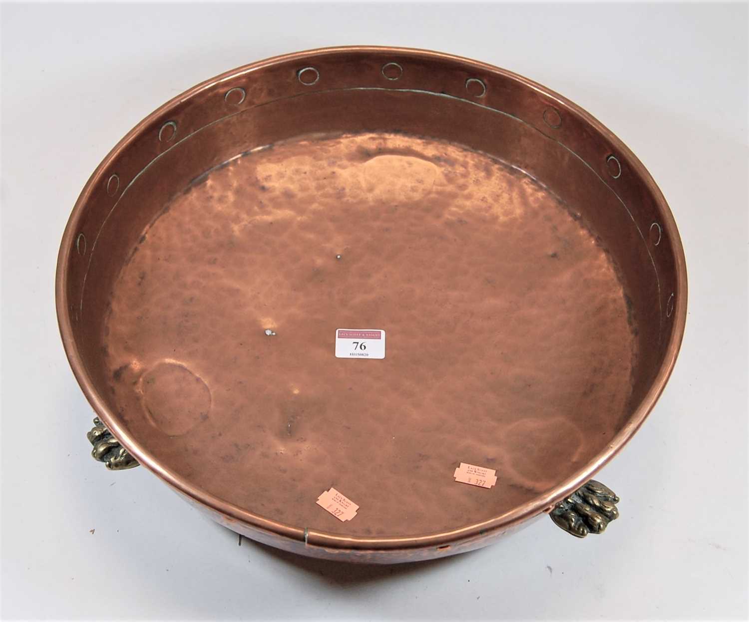 Lot 76 - A hammered copper preserve pan with brass lion...
