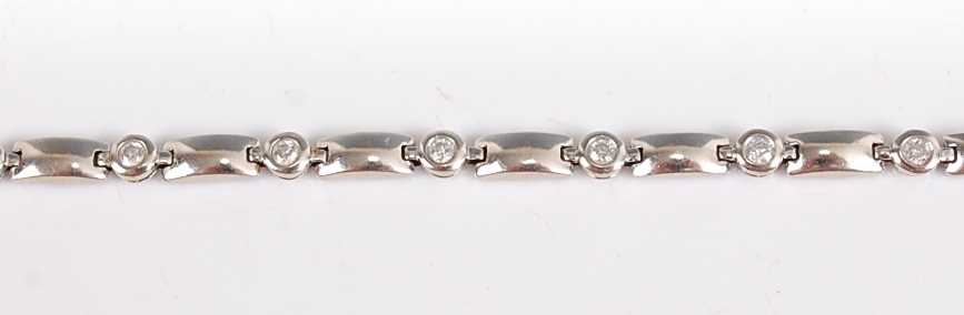 Lot 1244 - A white metal diamond line bracelet, having...