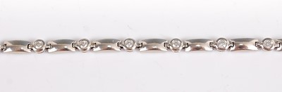 Lot 1244 - A white metal diamond line bracelet,  having...