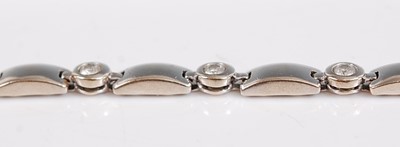 Lot 1244 - A white metal diamond line bracelet, having...