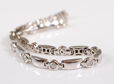 Lot 2686 - A white metal diamond line bracelet, having...