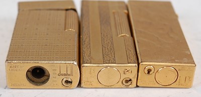 Lot 193 - A collection of three Dunhill gilt metal...
