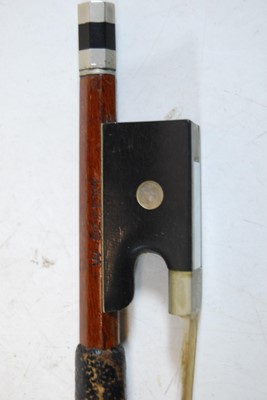 Lot 615 - A German nickel mounted violin bow having an...