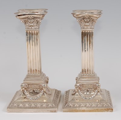 Lot 1170 - A pair of Edwardian silver candlesticks, each...