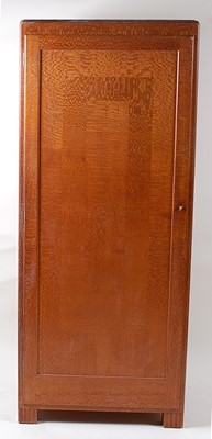 Lot 299 - An Art Deco oak single door wardrobe by Betty...