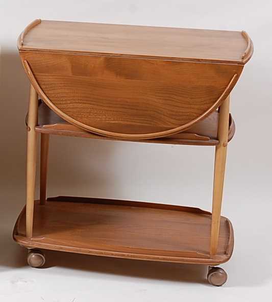 Lot 354 - An Ercol light elm dropflap three-tier tea...